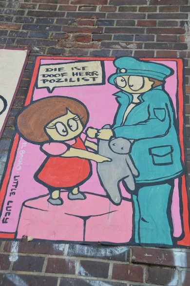 Little Lucy is in 2003 bedacht door El Bocho en is gebaseerd op de Tsjechische televisieserie 'Lucy – streets bugaboo'. Lucy staat vaak afgebeeld met een kat, die het meestal moet ontgelden. Vanwege de populariteit van Little Lucy heeft El Bocho er een draai aangegeven door oa toeristen te waarschuwen.