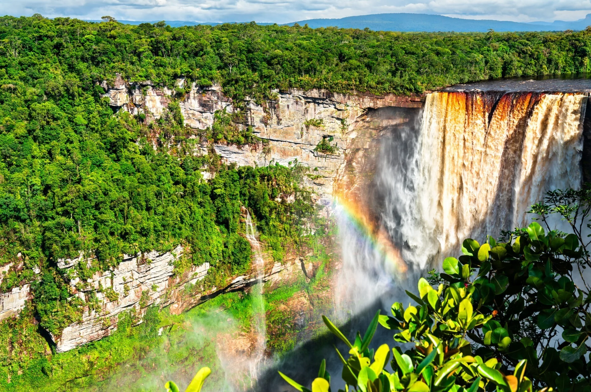 Kaieteur Falls with a rainbow in Amazon rainforest of Guyana. One of the highest and most powerful waterfalls in the world